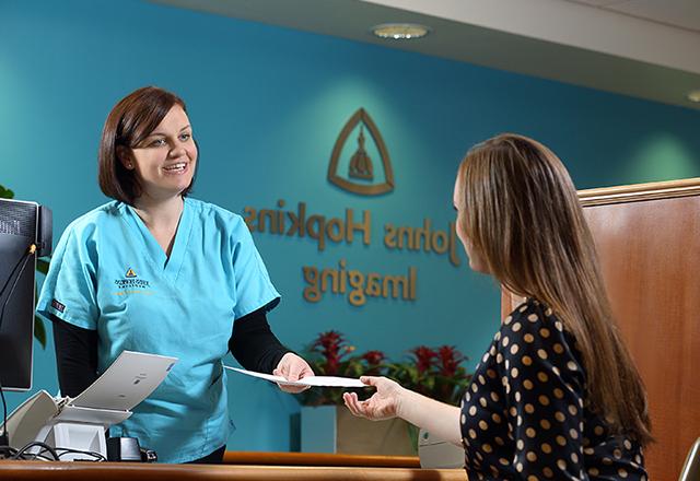 Practitioner checks in patient at Hopkins imaging center