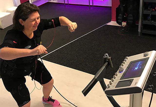 Vivienne using a machine while exercising.