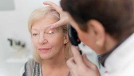 senior women having eye looked at by doctor