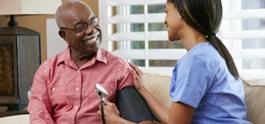 older man speaking to nurse