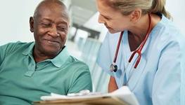 older man consulting with female doctor