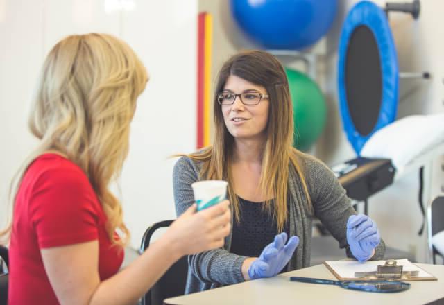 A speech-language pathologist conducting a swallowing test