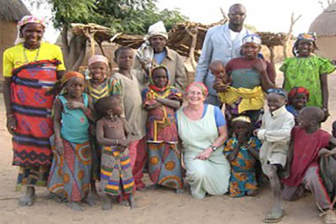 Dr. Sheila West in Africa with local residents